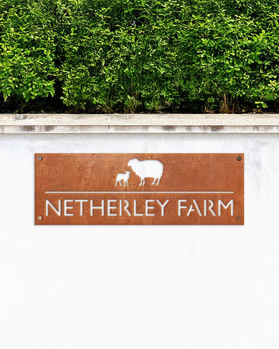 Sheep & Lamb Corten Steel House Name Sign in Situ on a White Garden Wall