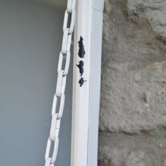 Close up of rustic detailing and chain  Close up of rustic detailing and chain