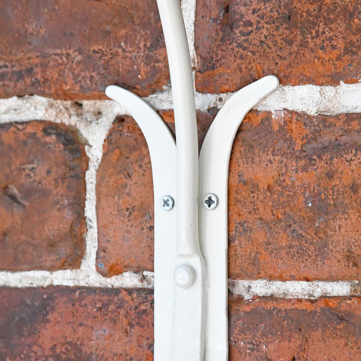 Close-up of the Top of the Fixing Plate Mounted on a Brick Wall Close-up of the Top of the Fixing Plate Mounted on a Brick Wall