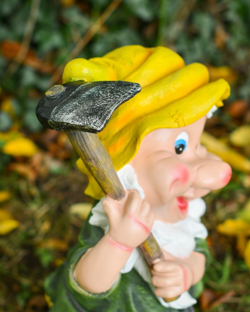 Close up of gardening tool on colourful gardening gnome ornament