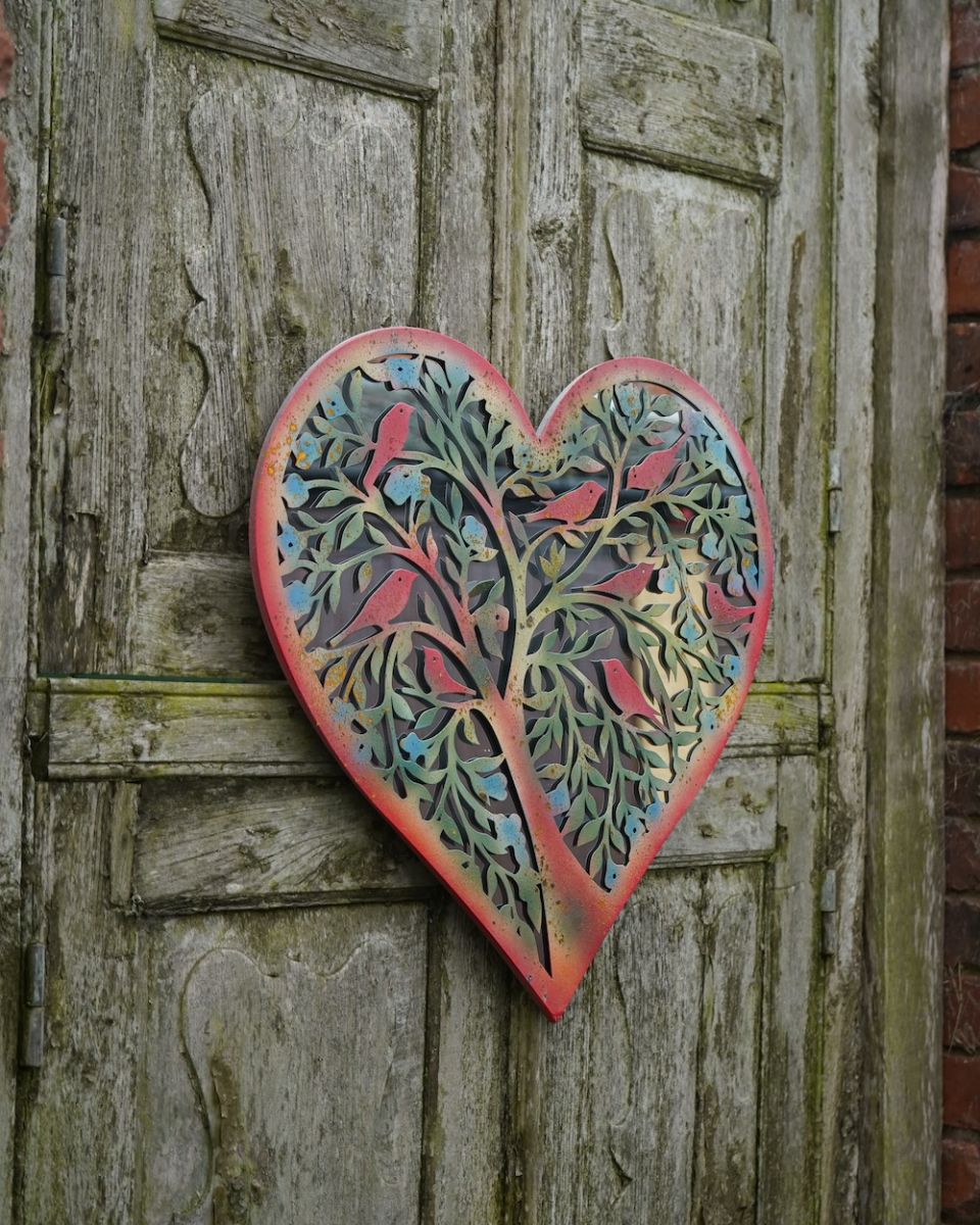 Side view of colourful steel overlay garden mirror wall art