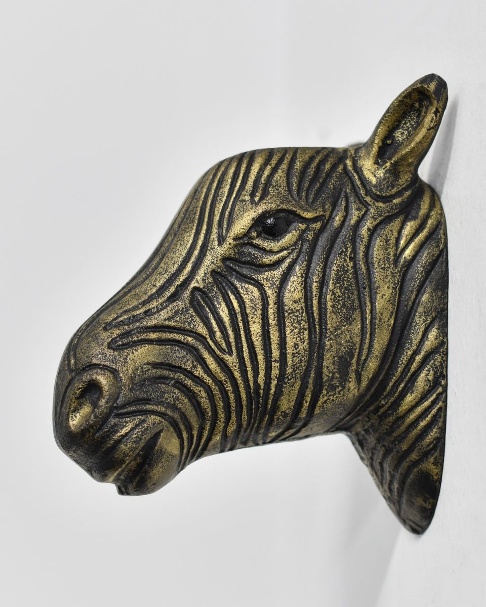side view of black and gold animal wall bust