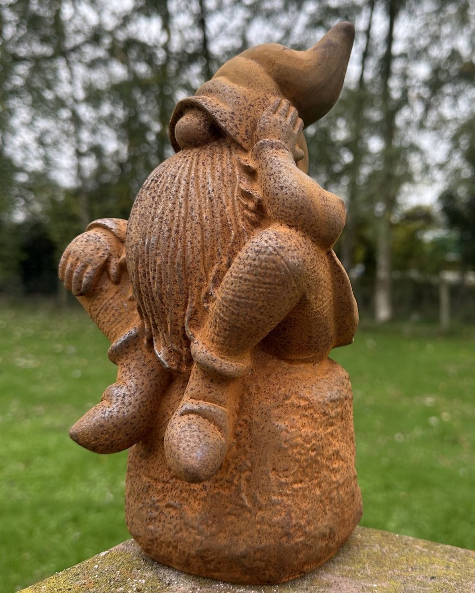 Side view of rustic finish gnome garden sculpture Side view of rustic finish gnome garden sculpture