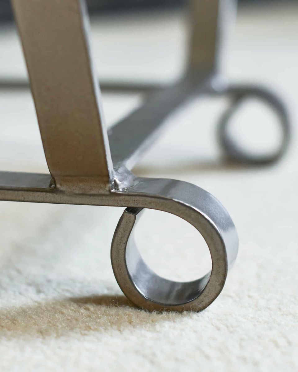 Close-Up of Arched Feet Design on Simplistic Antique Pewter Finish Log Holder