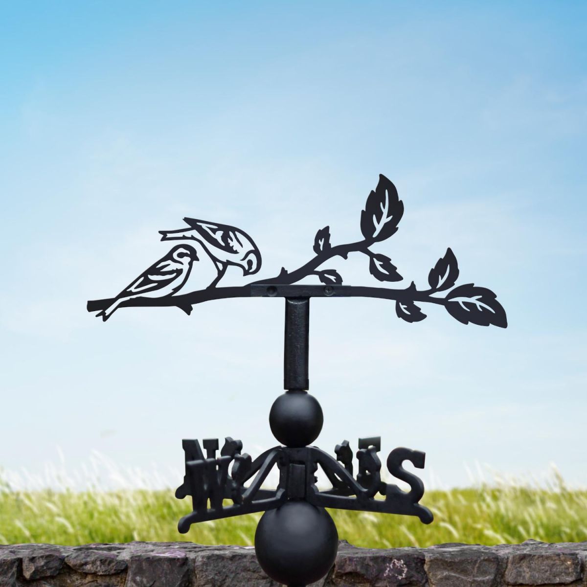 Siskin weathervane in a summery setting Siskin weathervane in a summery setting