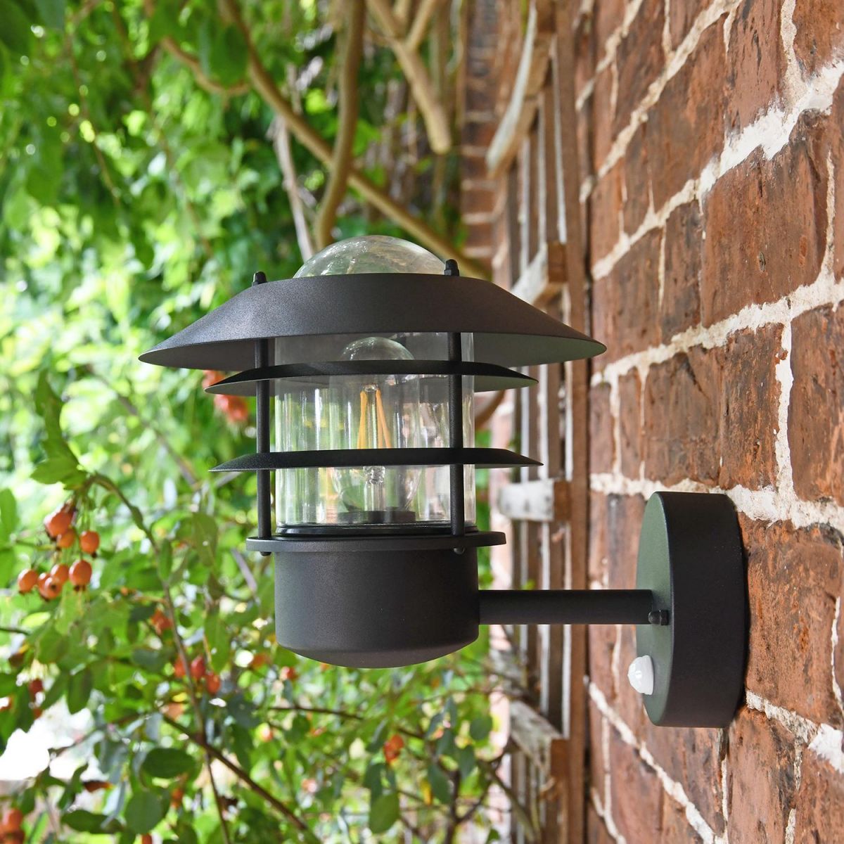 Side View of the "Skive" Black Contemporary Wall Light Mounted on a Brick Wall
