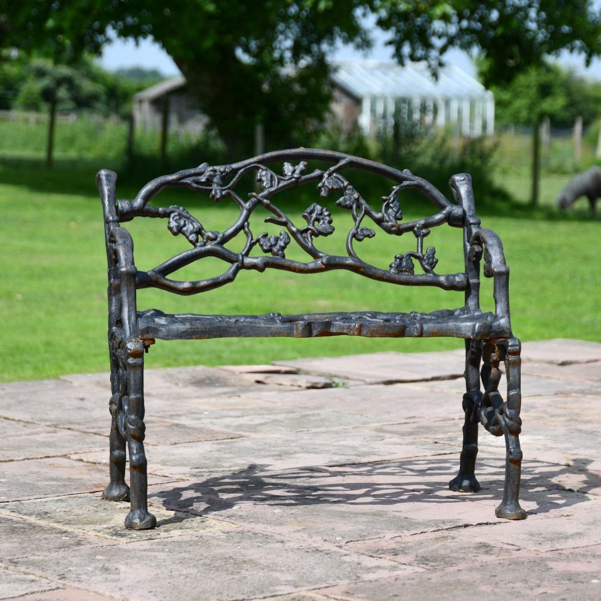 Front view of Cast Iron Aged Black Garden Bench in situ 