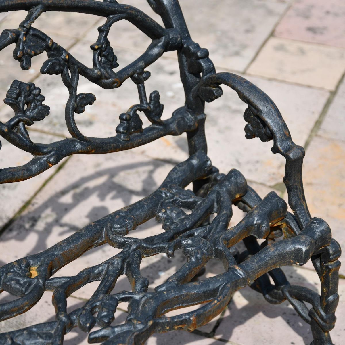 Close up of branch detailing throughout cast iron garden bench
