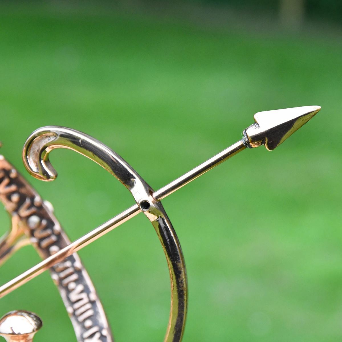 Close-up of the Arrow on the Polished Solid Copper Armillary