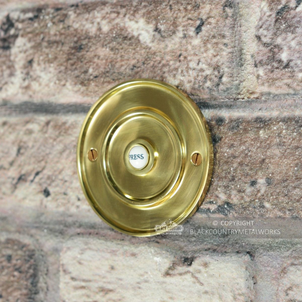 Sovereign Park Polished Brass Classic Bell Push On Brick Wall