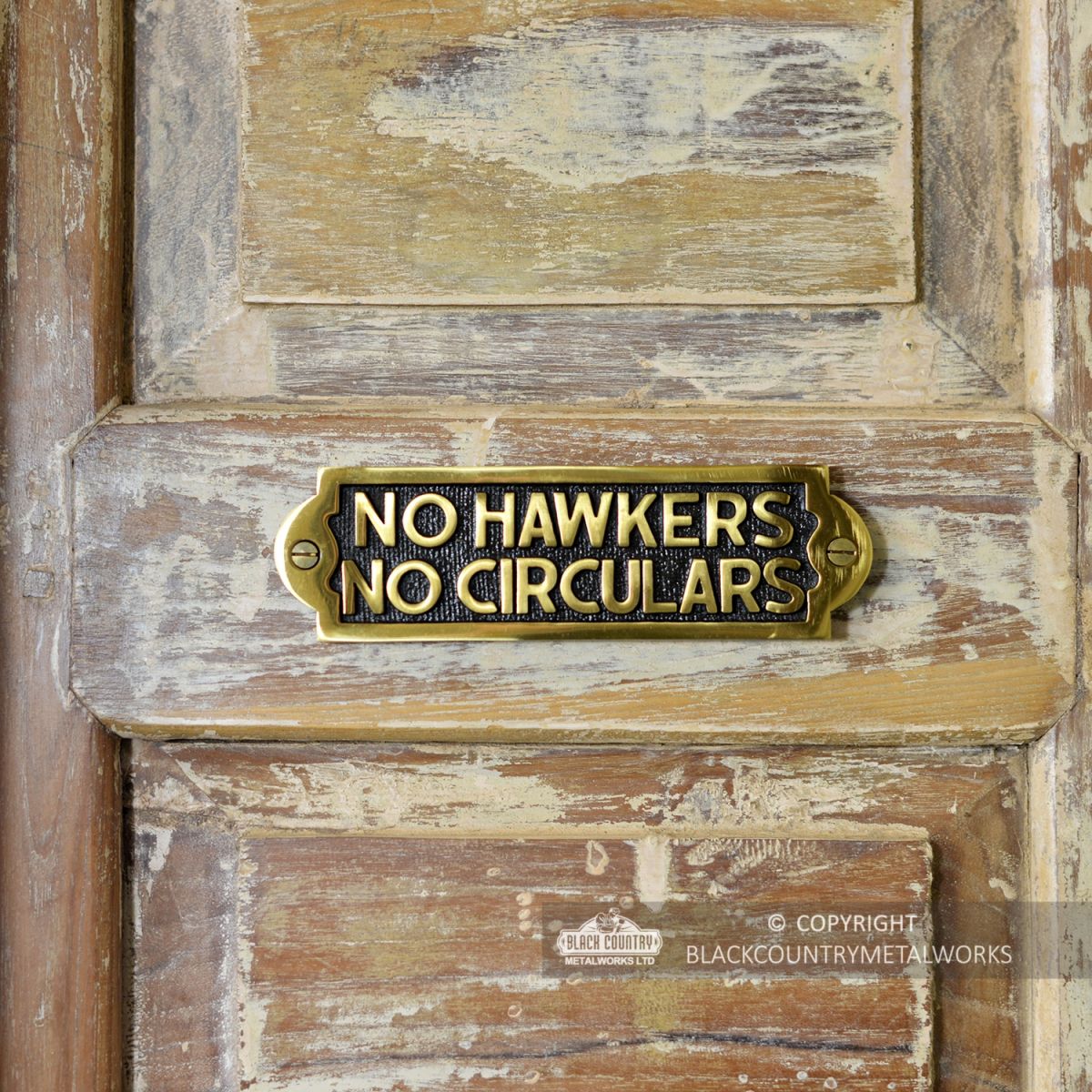 "No Hawkers No Circulars" Sign in Situ on a Rustic Wooden Surface