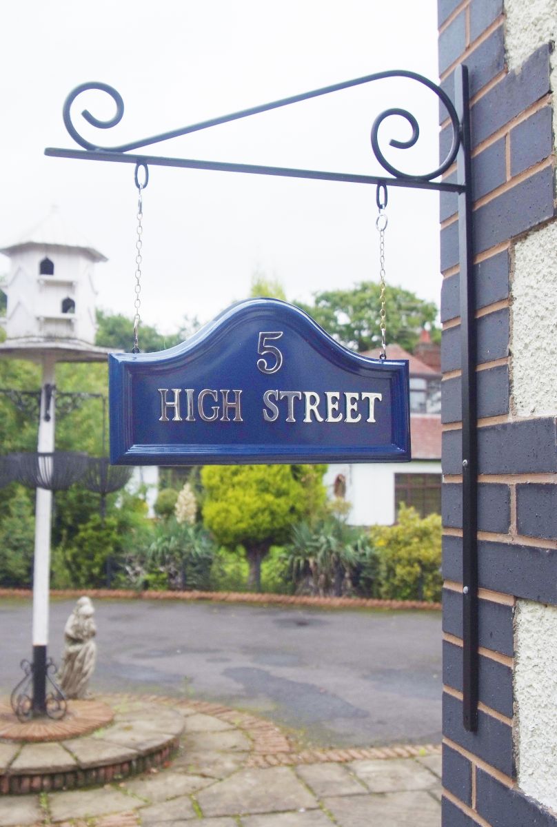 Blue Arched Hanging House sign on bracket attached to wall