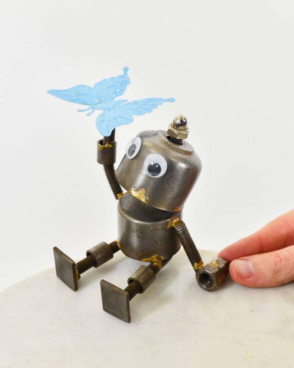 "Sprocket" the Upcycled Metal Home Ornament blue with hand in shot for scale