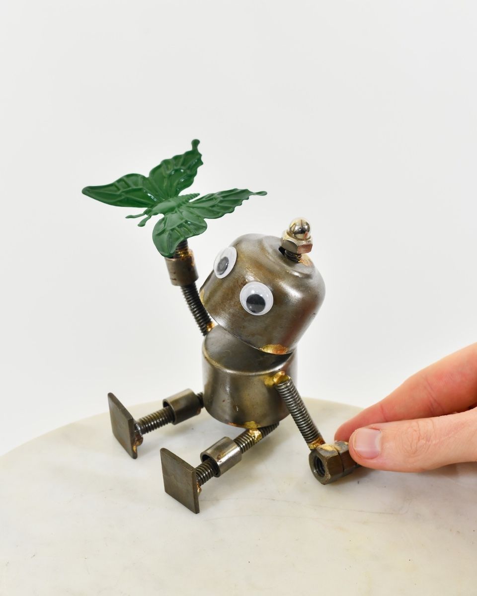 "Sprocket" the Upcycled Metal Home Ornament green with hand in shot for scale