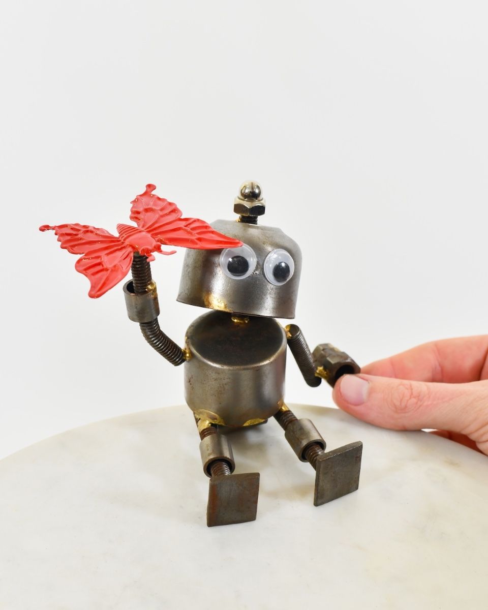 "Sprocket" the Upcycled Metal Home Ornament red with hand in shot for scale