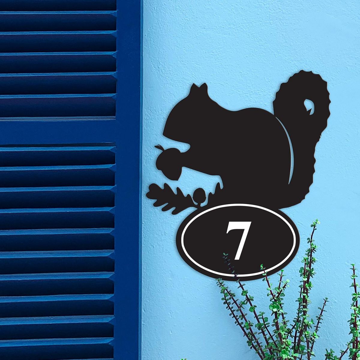Squirrel Iron House Number Sign in Situ on a Blue Wall