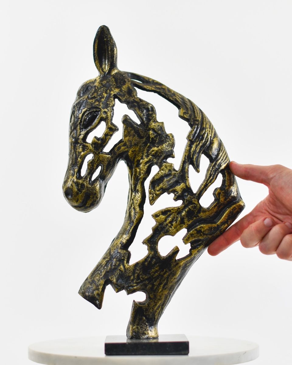 Steed"s Shadow Cast Aluminium Interior Ornament - Gold with hand in shot for scale
