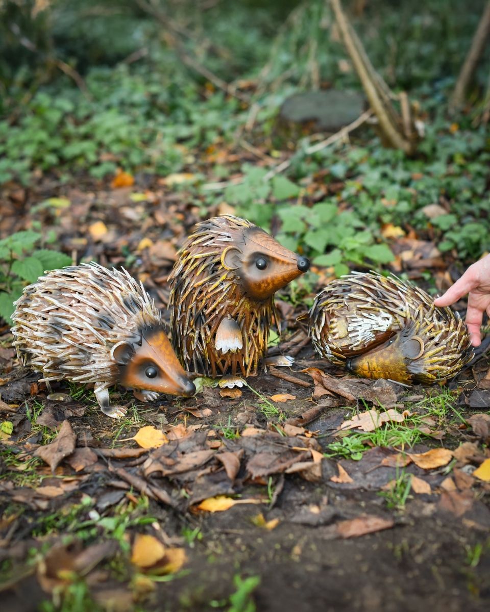 Steel Hedgehog Family Garden Ornaments with hand in shot for scale