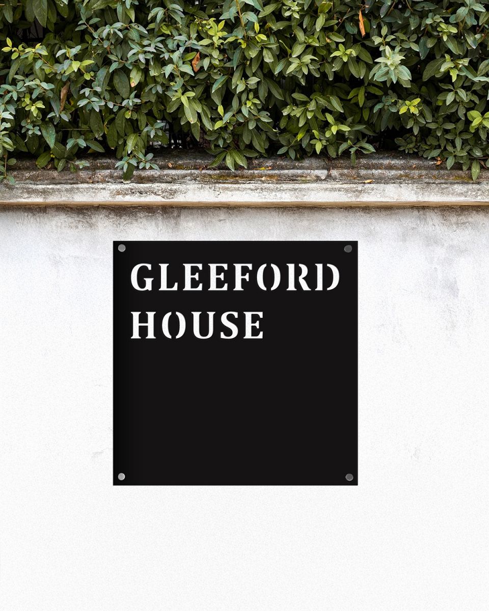 Steel Square House Name Sign In Situ on a White Garden Wall