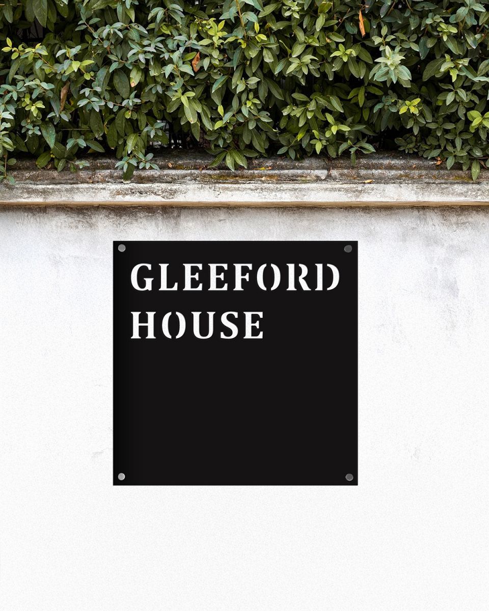 Steel Square House Name Sign In Situ on a White Garden Wall