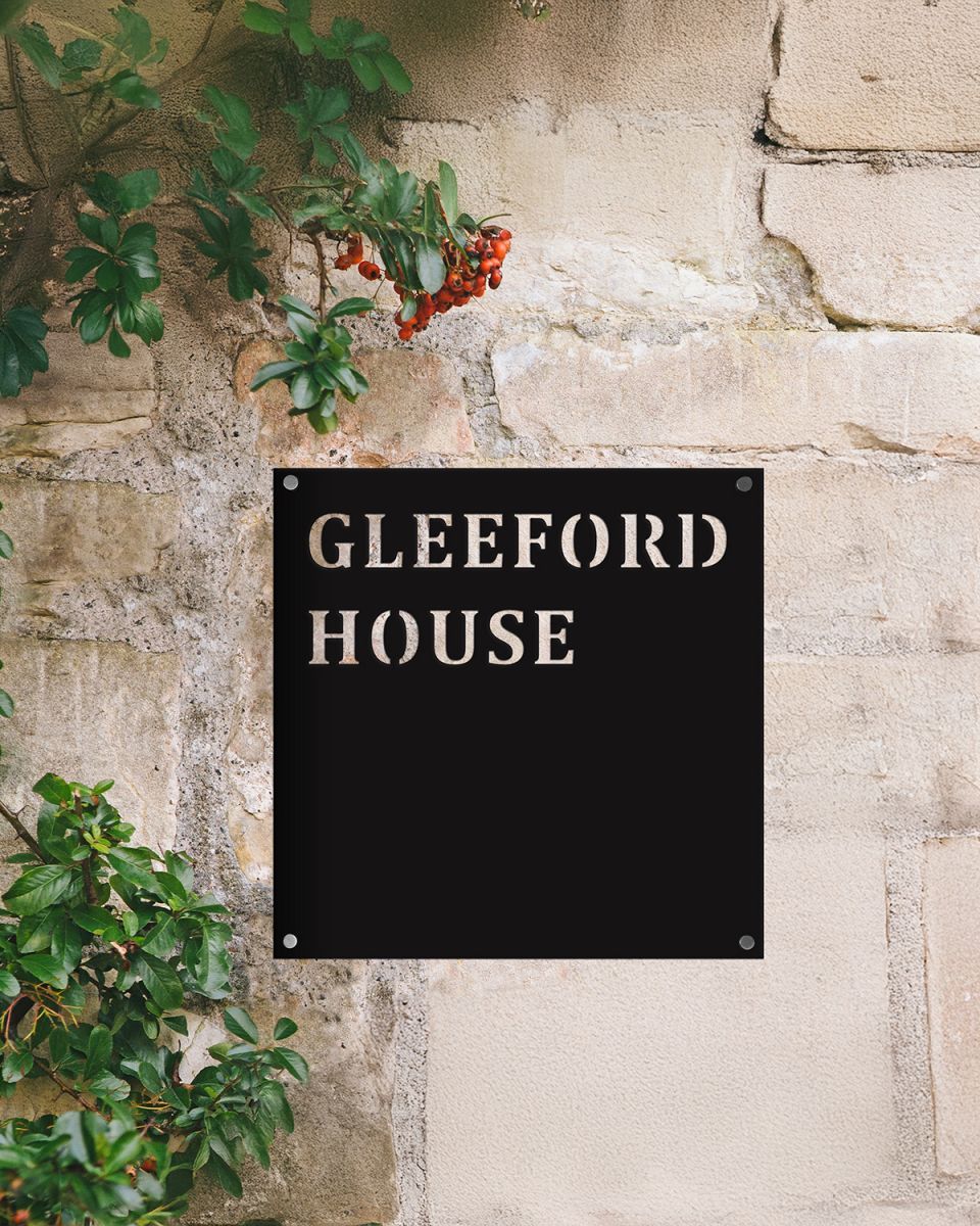 Steel Square House Name Sign on Rustic Sandstone Wall