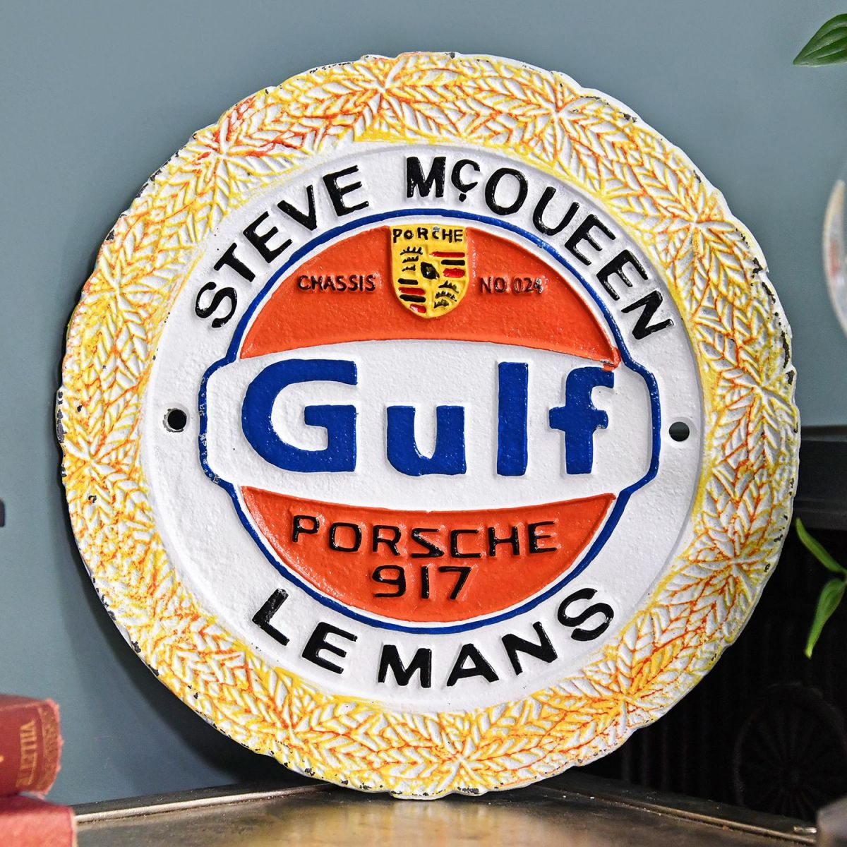 Steve McQueen "Gulf" Cast Automobilia Reproduction Sign in Situ Next to a Blue Wall