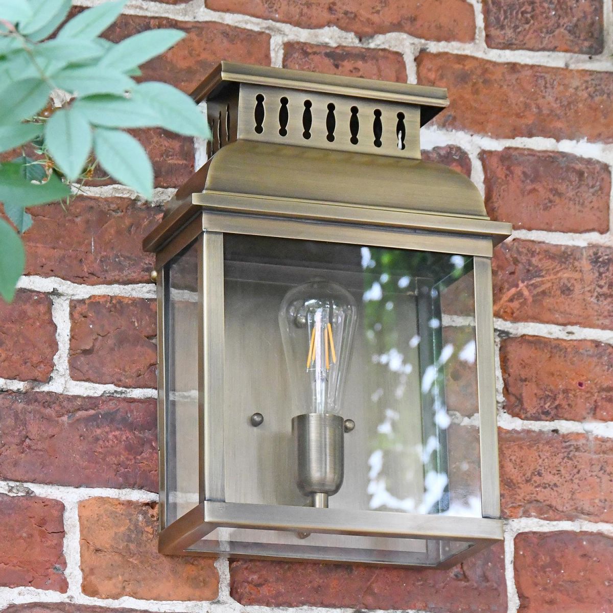 "Stoneford Park" Antique Brass Half Wall Lantern on a Garden Wall