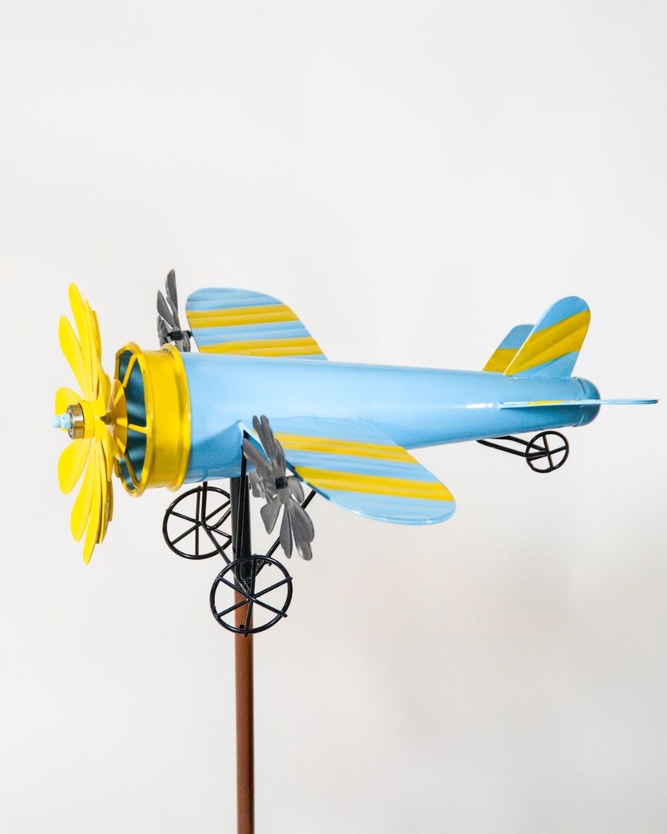 Vintage Airplane Wind Spinner Stakes in Blue and Yellow on a White Background