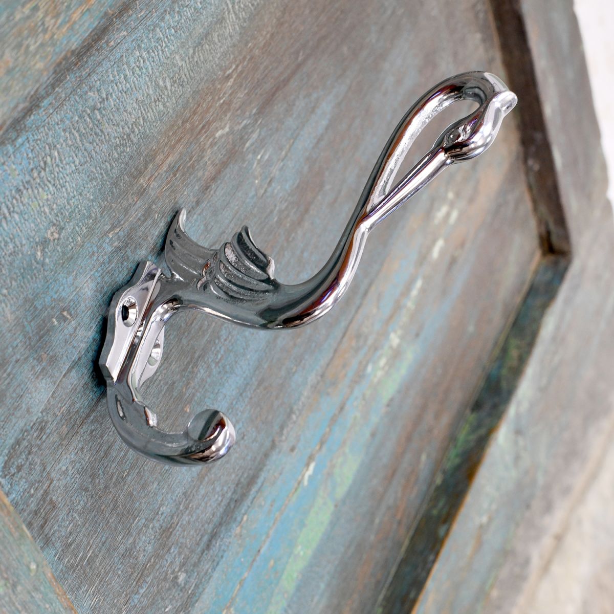 Bright Chrome Swan Coat Hook on a Shabby Chic Surface