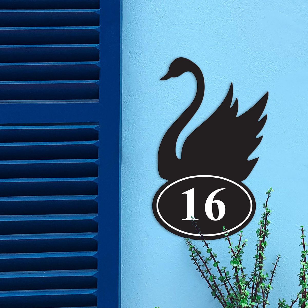 Iron Swan House Number Sign in Situ on a Blue Wall 