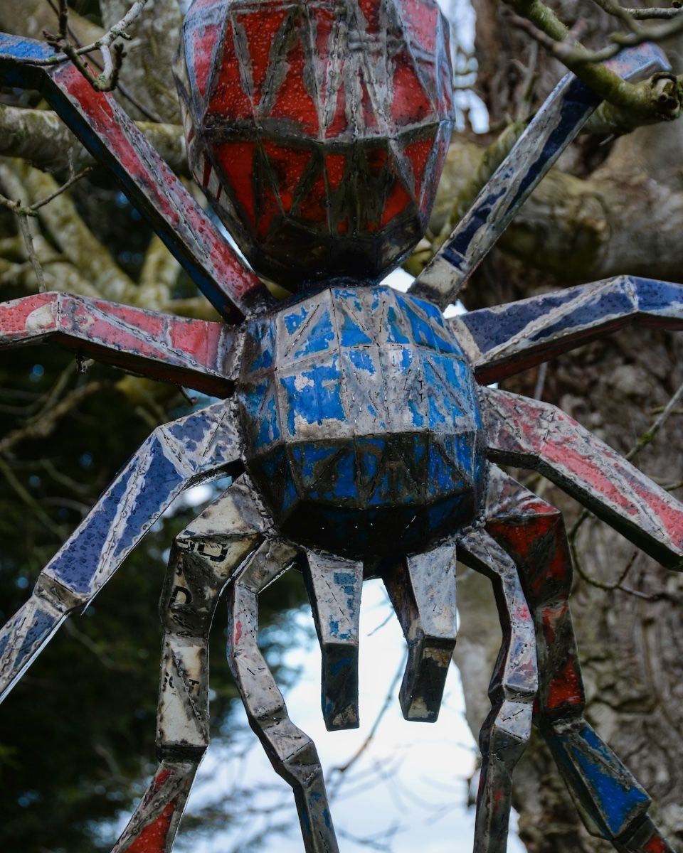 Tarantula Upcycled Oil Drum Garden Sculpture hanging from a tree close up image