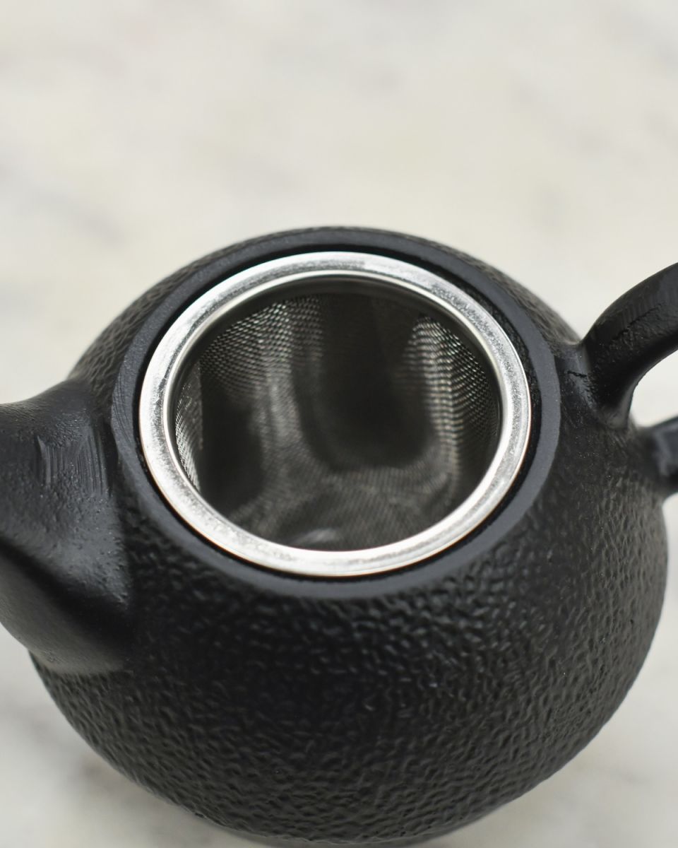Tea strainer detail on cast iron japanese tea set Tea strainer detail on cast iron japanese tea set