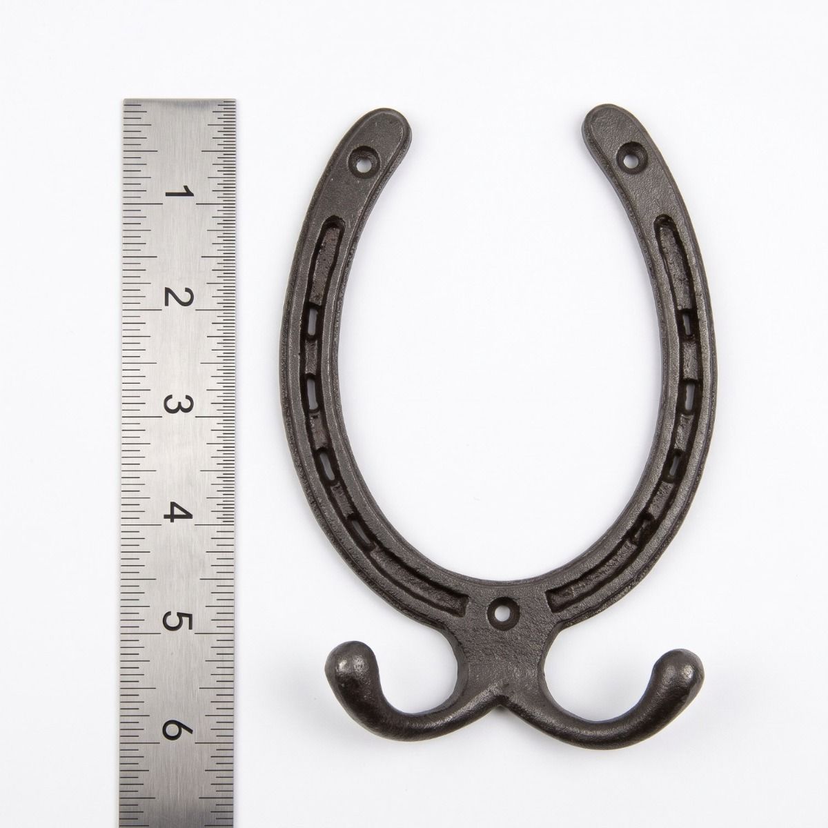 The Blacksmith Vintage Cast Iron Horseshoe Robe Hook next to a Ruler On a White Background  - Digital Illustration