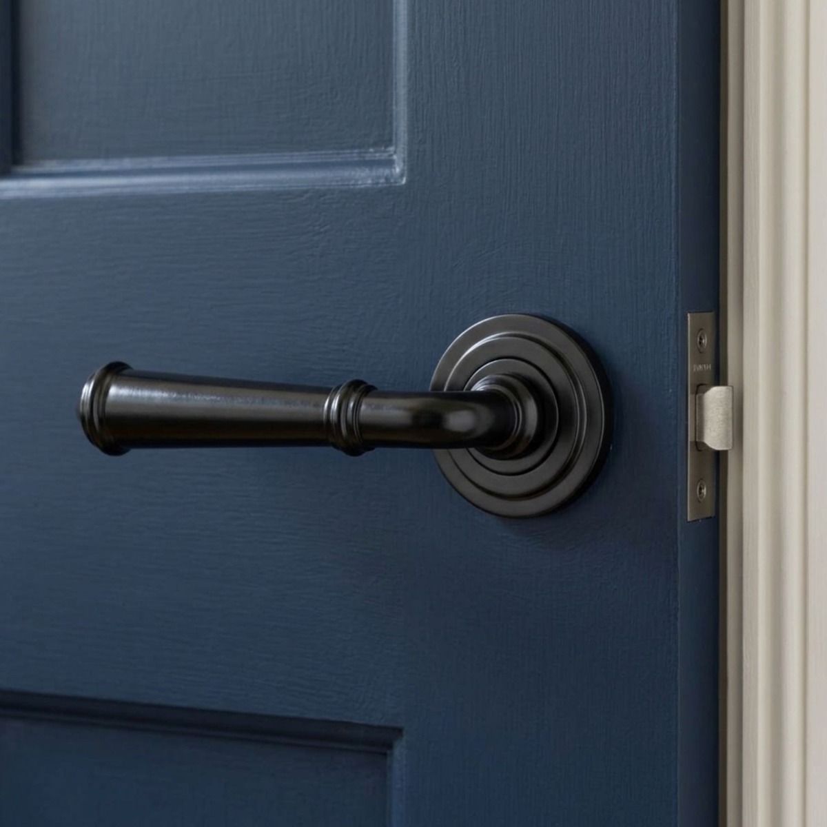 The Edlyn House Midnight Black Unsprung Lever Door Handle on Art Deco Rose in a Modern Interior Setting Mounted on a Door - Digital Illustration
