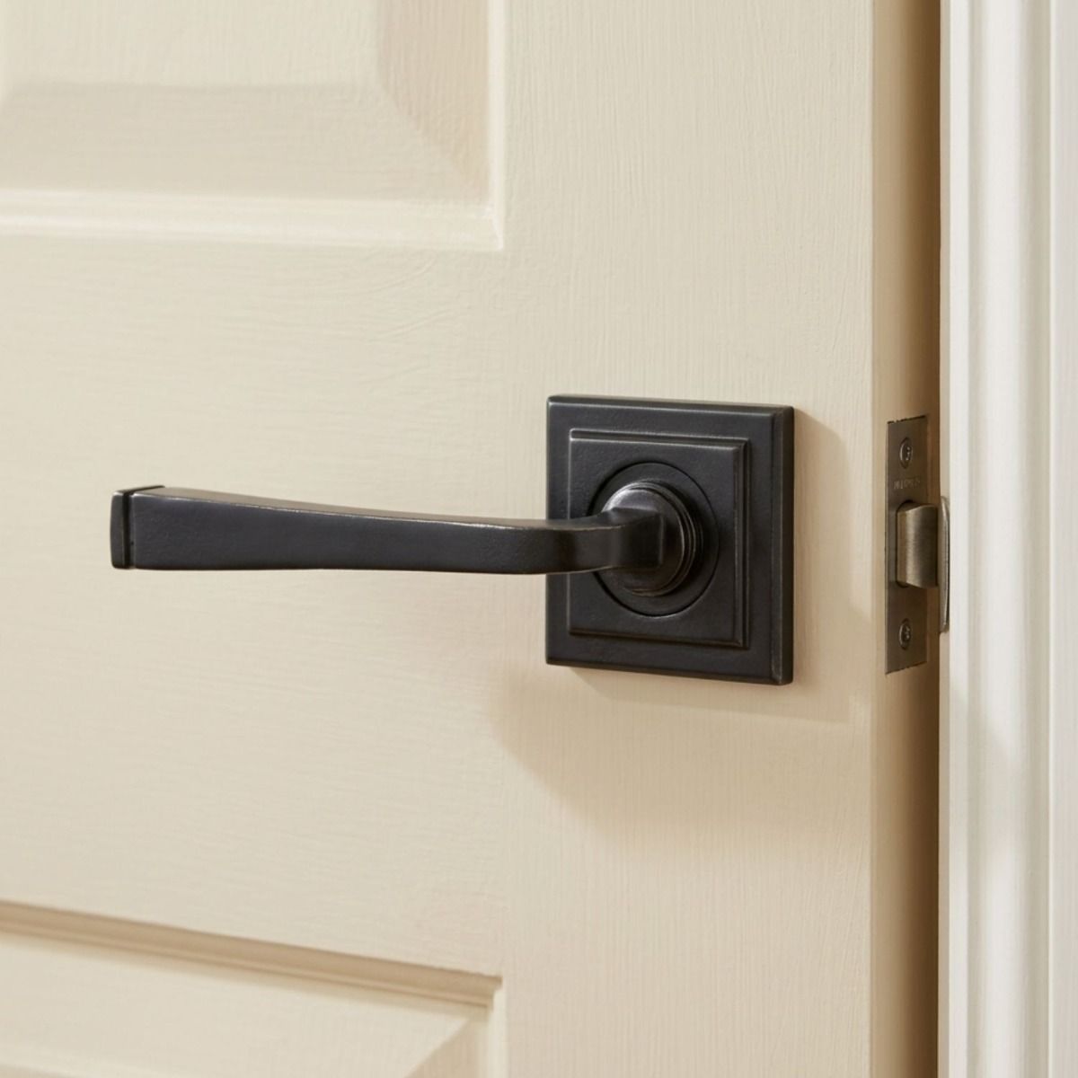 The Grayson Manor Midnight Black Unsprung Lever Door Handle on Square Rose Mounted onto a Cream Coloured Door in an Open Position - Digital Illustration