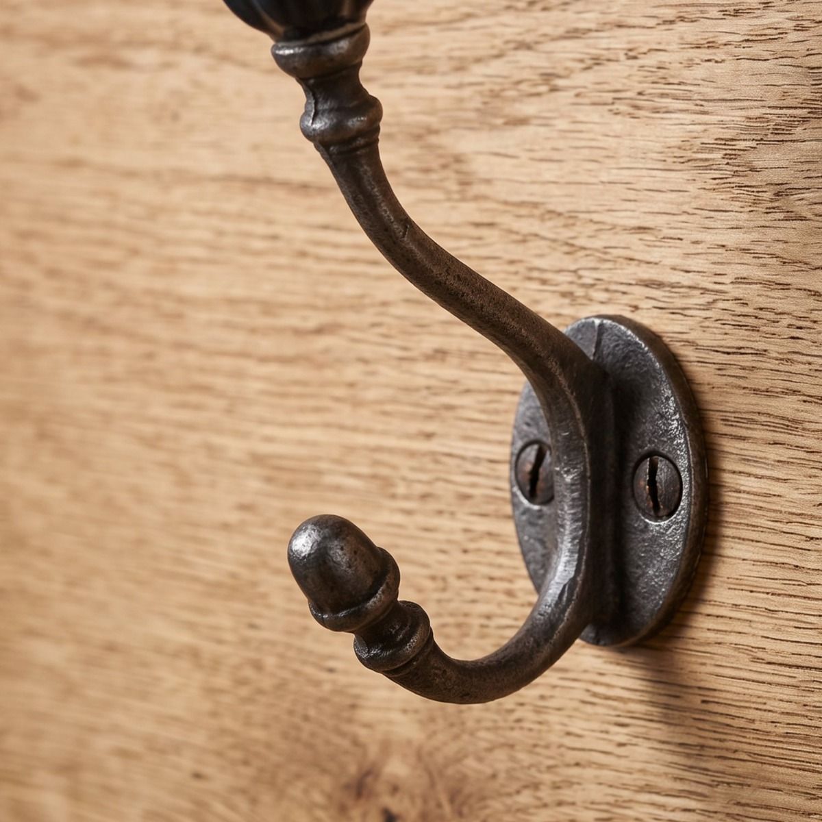 The Ironmonger Acorn Dark Green Ceramic Coat Hook - 125mm Showing a Close up of the Lower Hook - Digital Illustration