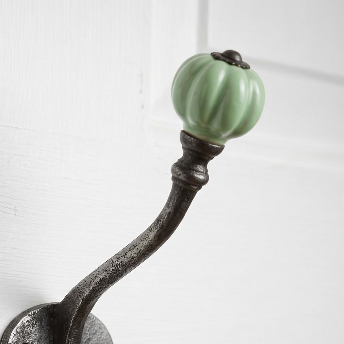The Ironmonger Acorn Light Green Ceramic Coat Hook - 125mm Showing a Close up of the Ceramic Rounded Finial - Digital Illustration