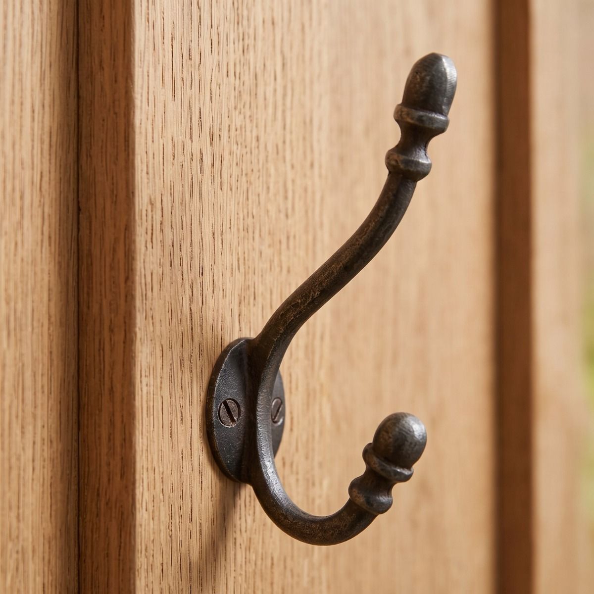 The Regency Oval Backplate Acorn Hook - 130mm Shown on the Back of a Timber Door - Digital Illustration