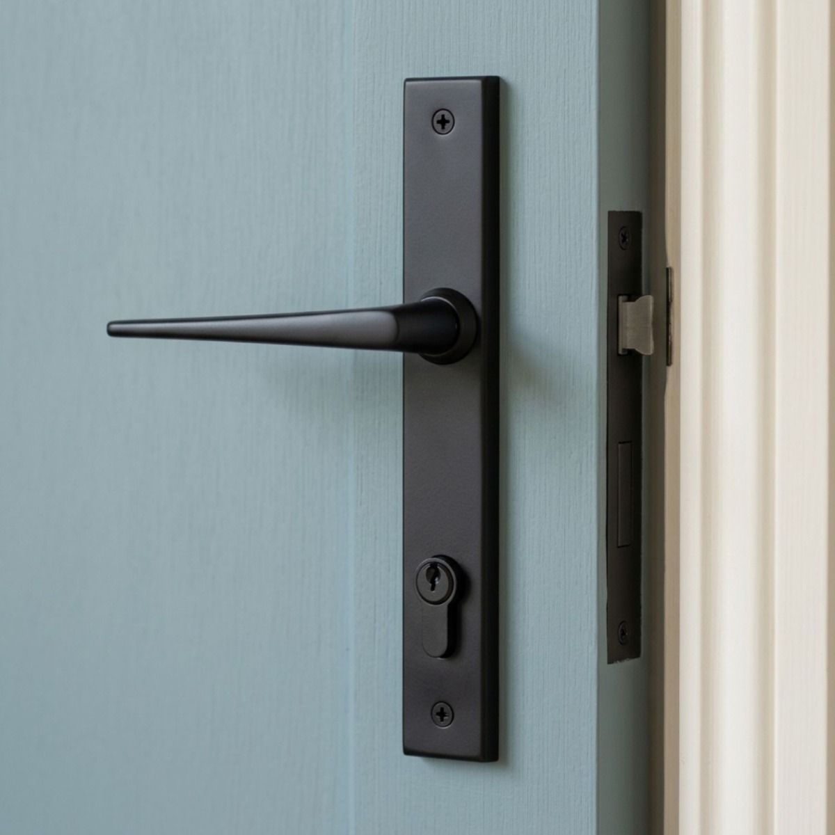The Slimline Lever Espagnolette Door Latch in Aged Bronze Mounted onto a Light Blue Door in a Modern Home - Digital Illustration