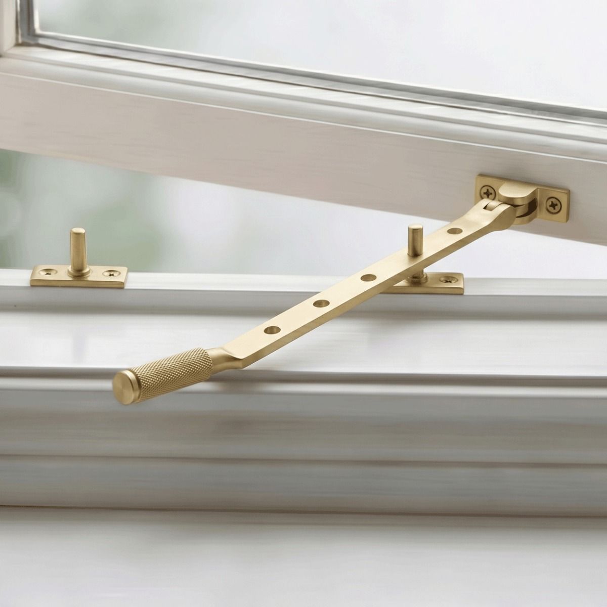 The 12" Satin Brass "Royale" Five Pin Window Stay Fitted on a Classic White Window - Digital Illustration