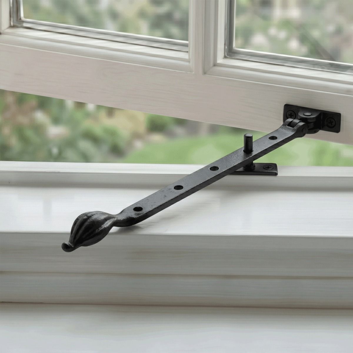 The 12" Traditional Black Iron Window Casement Stay With Petal Shaped Handle Fitted on an Open White Window - Digital Illustration