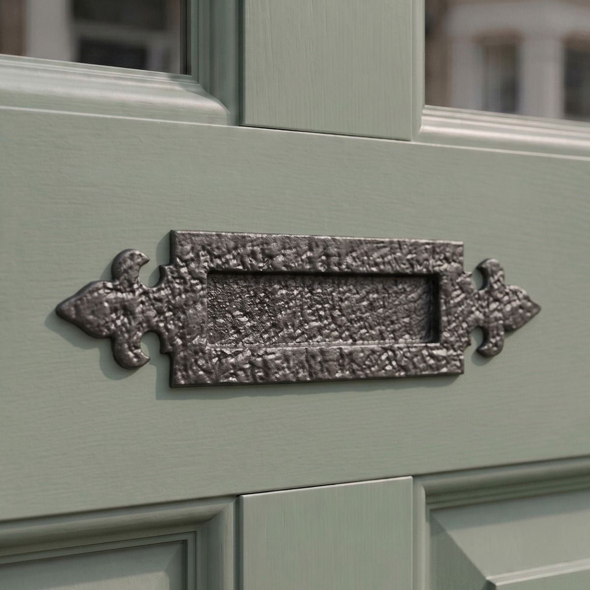 The 14¼" Antique Black Iron Fleur-De-Lys Inspired Door Letter Plate on a Sage Green Door to a Period Home - Digital Illustration