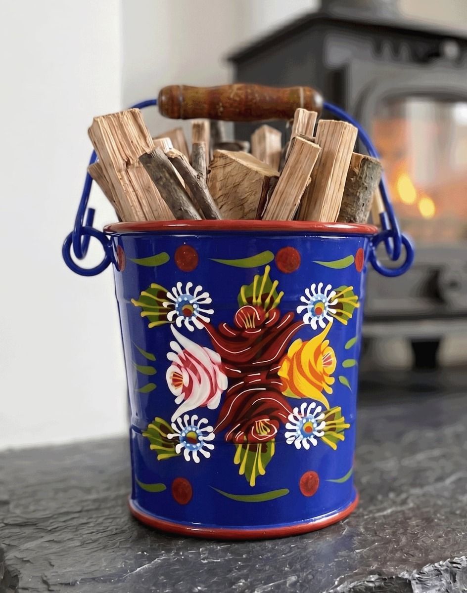 The 14cm Small Blue Narrowboat Hand Painted Bucket used for Holding Kindling Next to a traditional Log Burner Stove - Digital Illustration