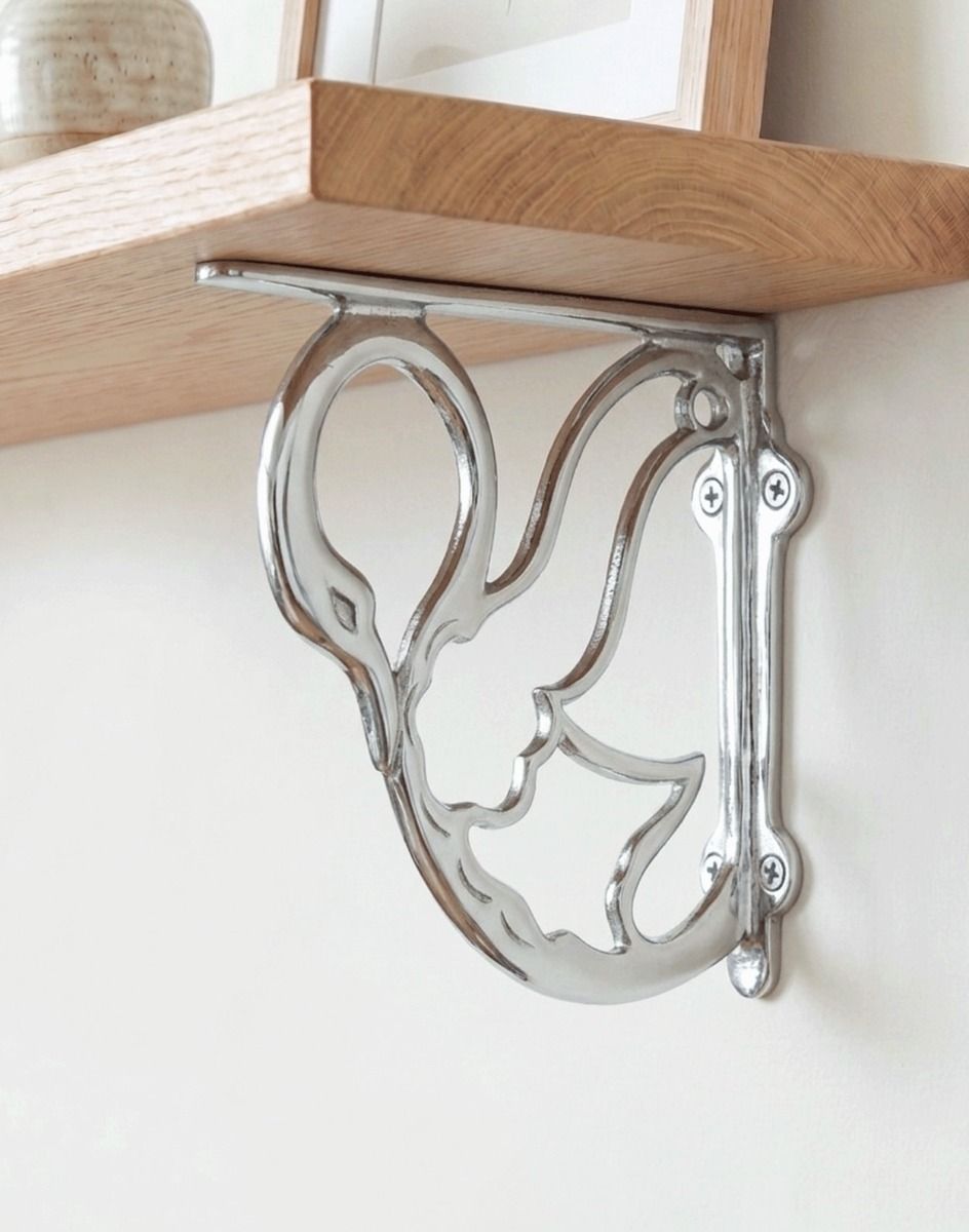 The 17cm x 20cm "Coscoroba" Bright Chrome Swan Shelf Bracket Mounted on a Contemporary Living Room Wall - Digital Illustration 