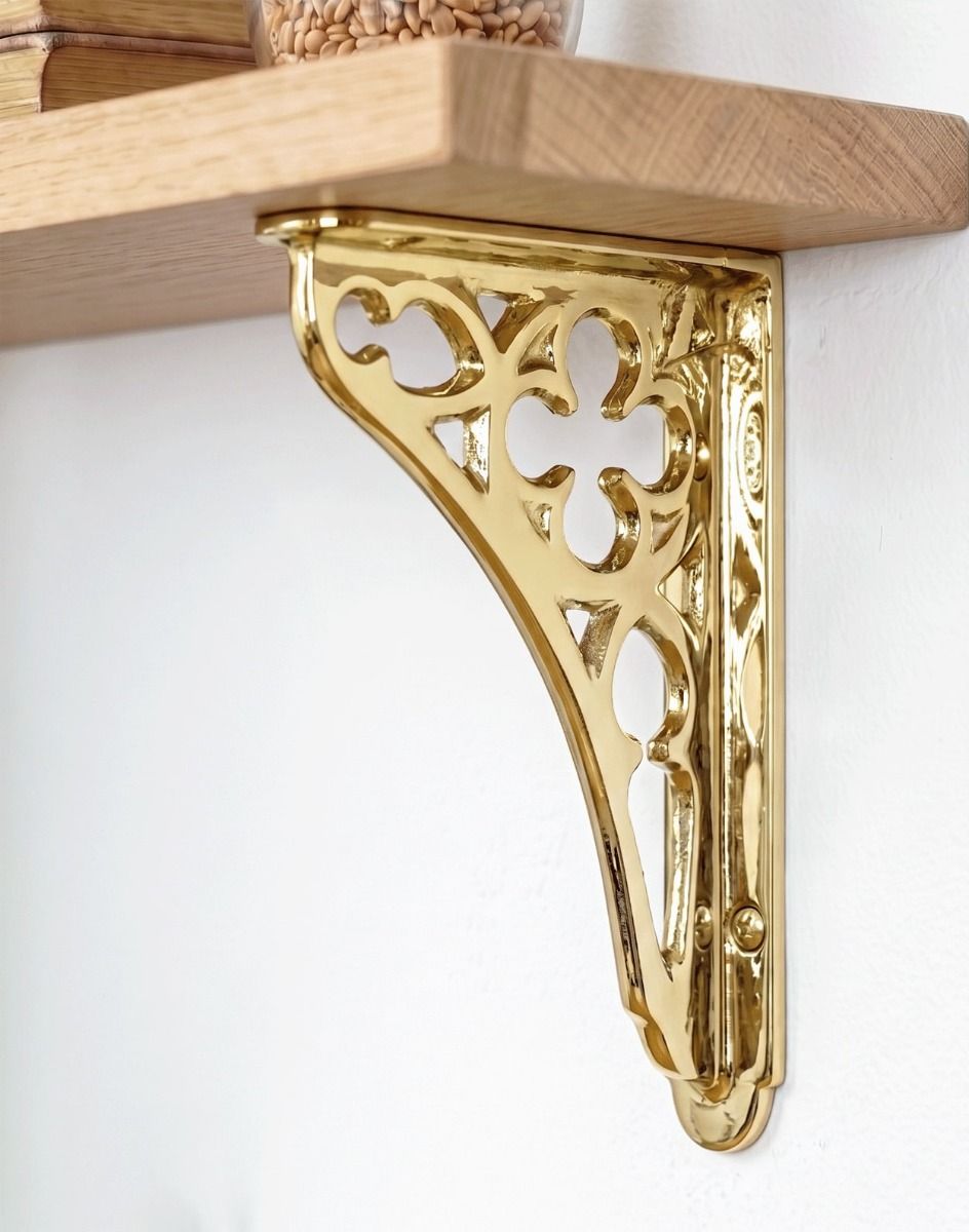 The 18 x 13cm Polished Brass Coalbrookdale Shelf Bracket Mounted on a White Interior Living Room Wall - Digital Illustration 