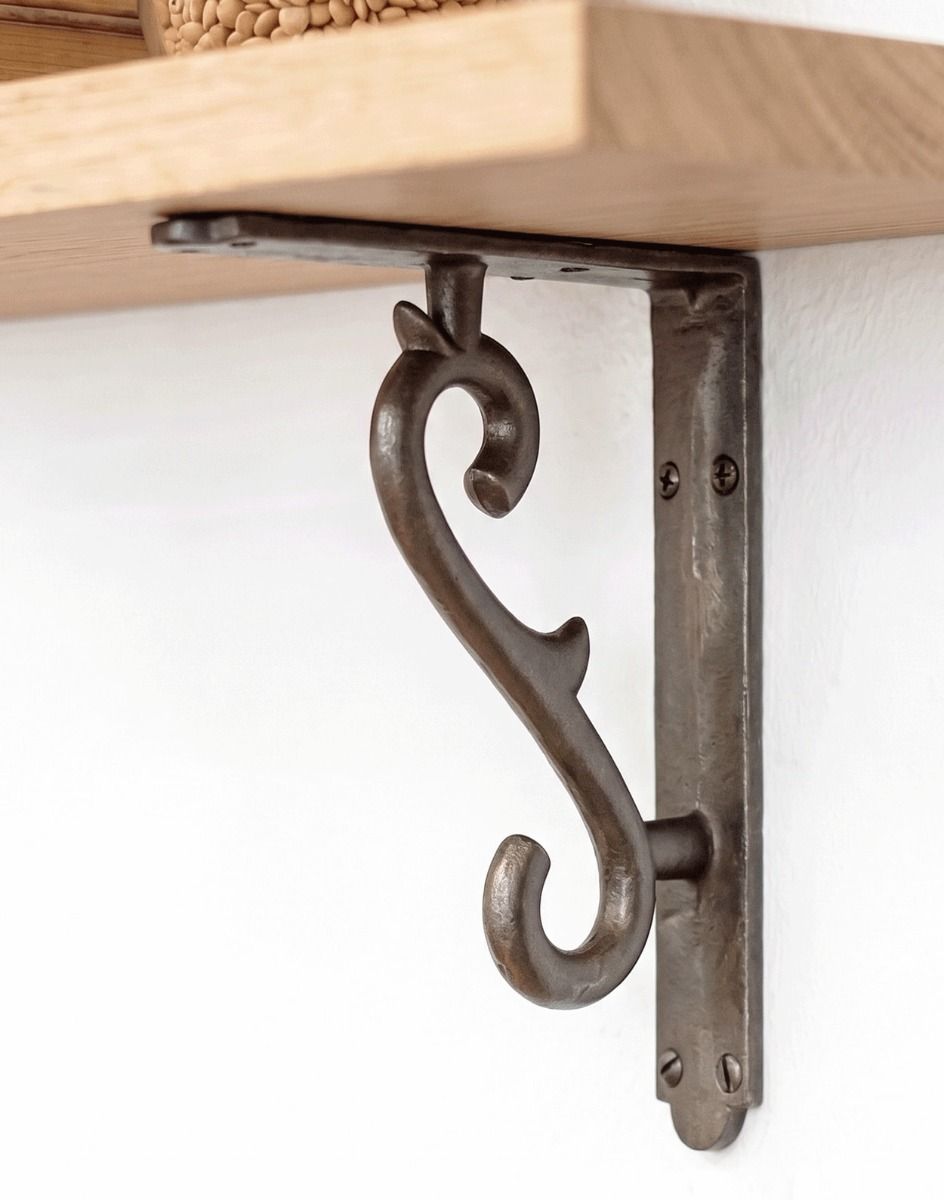 The 18 x 14.5cm Natural Iron Scroll Effect Wall Bracket Mounted on a Modern Living Room Wall - Digital Illustration