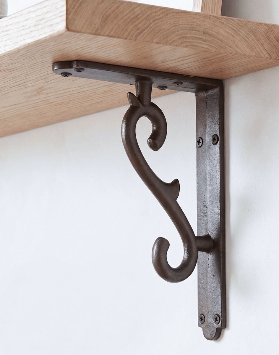 The 18 x 14cm Natural Iron Scroll Effect Wall Bracket Mounted on a White Coloured Modern Living Room Wall - Digital Illustration 