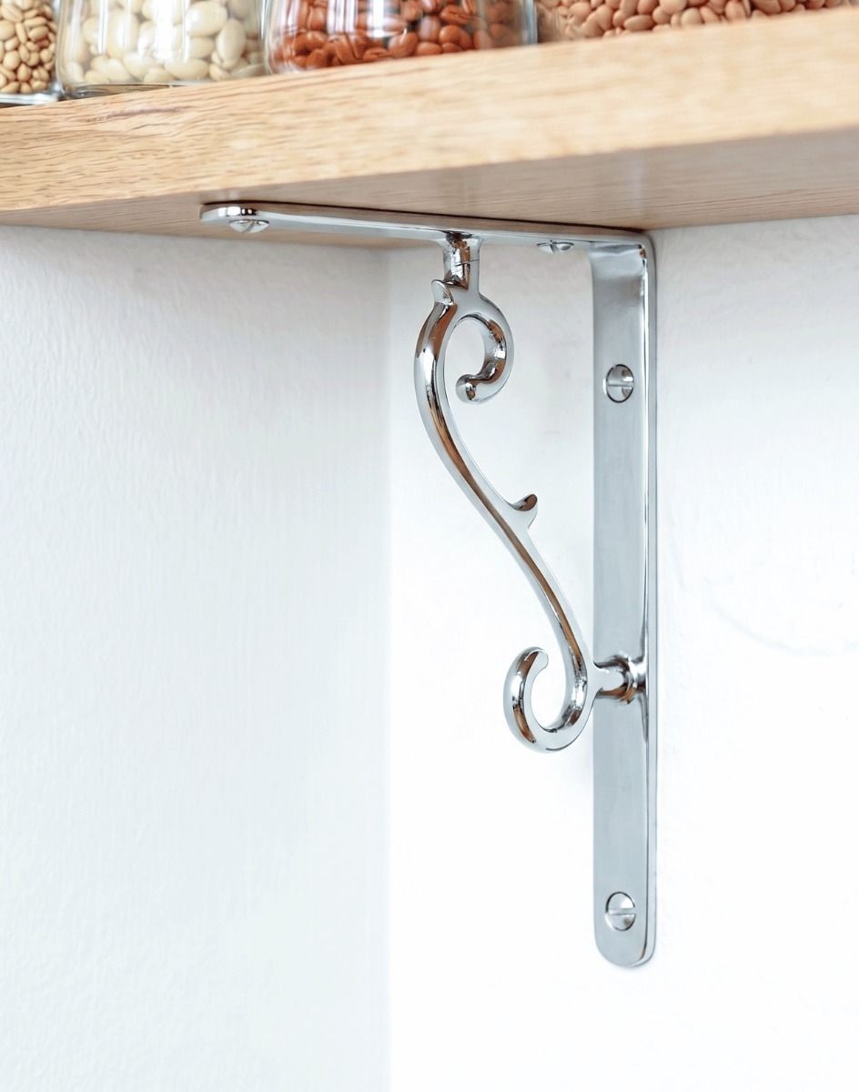 The 18cm x 14cm Scroll Effect Bright Chrome Shelf Bracket Mounted on a Modern White Kitchen Wall - Digital Illustration 