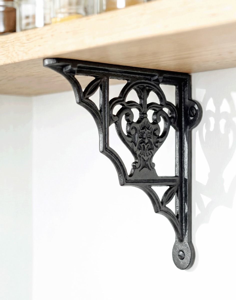 The 19 x 16cm "Blossville" Iron Shelf Bracket Mounted on a Wooden Shelf Attached to a Modern White Interior Wall - Digital Illustration 
