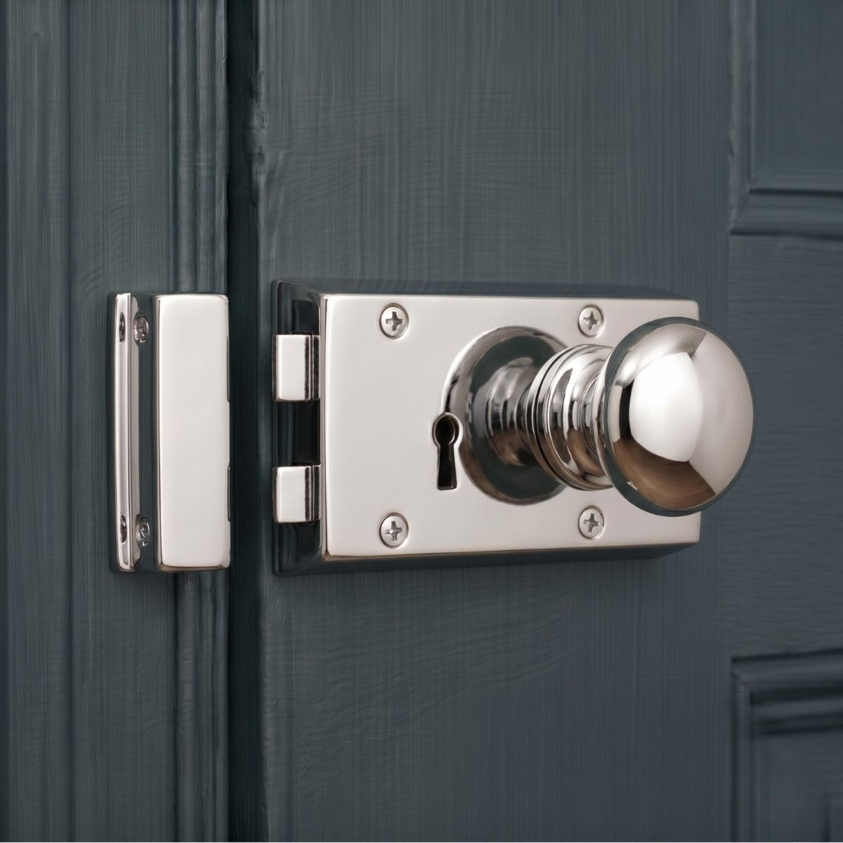The "Addingley" Bright Chrome Rim Latch Set Mounted on a Wooden Blue Period Door - Digital Illustration